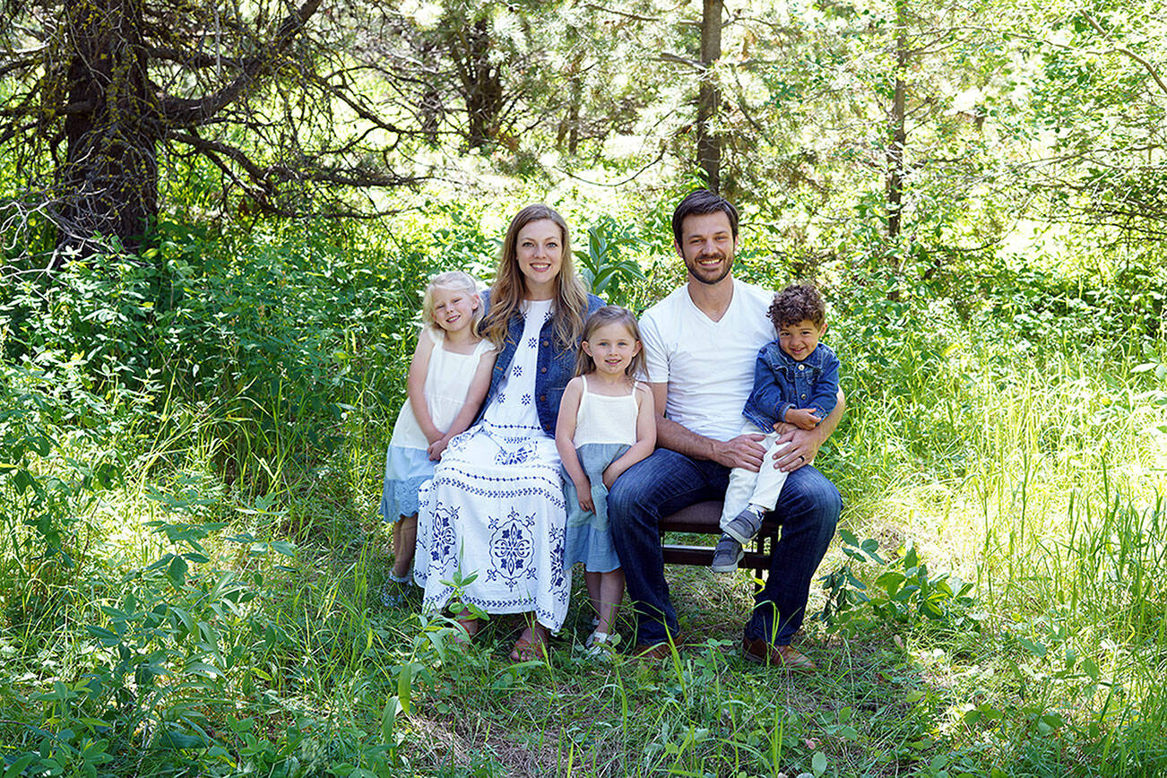 New Port Angeles High School assistant principal and athletic director Jarom Packer is pictured with his wife Merrin and three children.