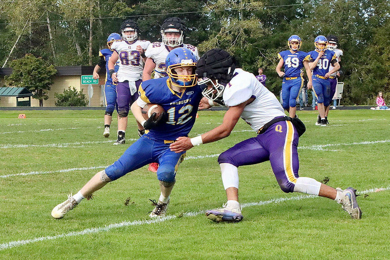 Crescent Logger #12 Mikah Love is met head on with Quilcenes #1 Andrew Perez-lopez. Note that Quilcene is wearing the guardian caps for added protection on plays such as this. Q #83 is Taylor Boling. Q #32 is Mason Iverson. C #49 is Connor Avertt. C #40 is Caden Seedorf. dlogan