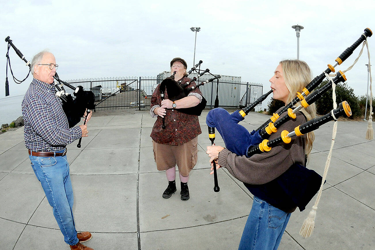 Bagpipers, from left, Tom McCurdy, Erik Evans and Heidi Slack, all of Port Angeles, perform together on Tuesday at Pebble Beach Park in Port Angeles. The trio were practicing songs to be played at 9/11 commemoration ceremonies across the North Olympic Peninsula. (Keith Thorpe/Peninsula Daily News)