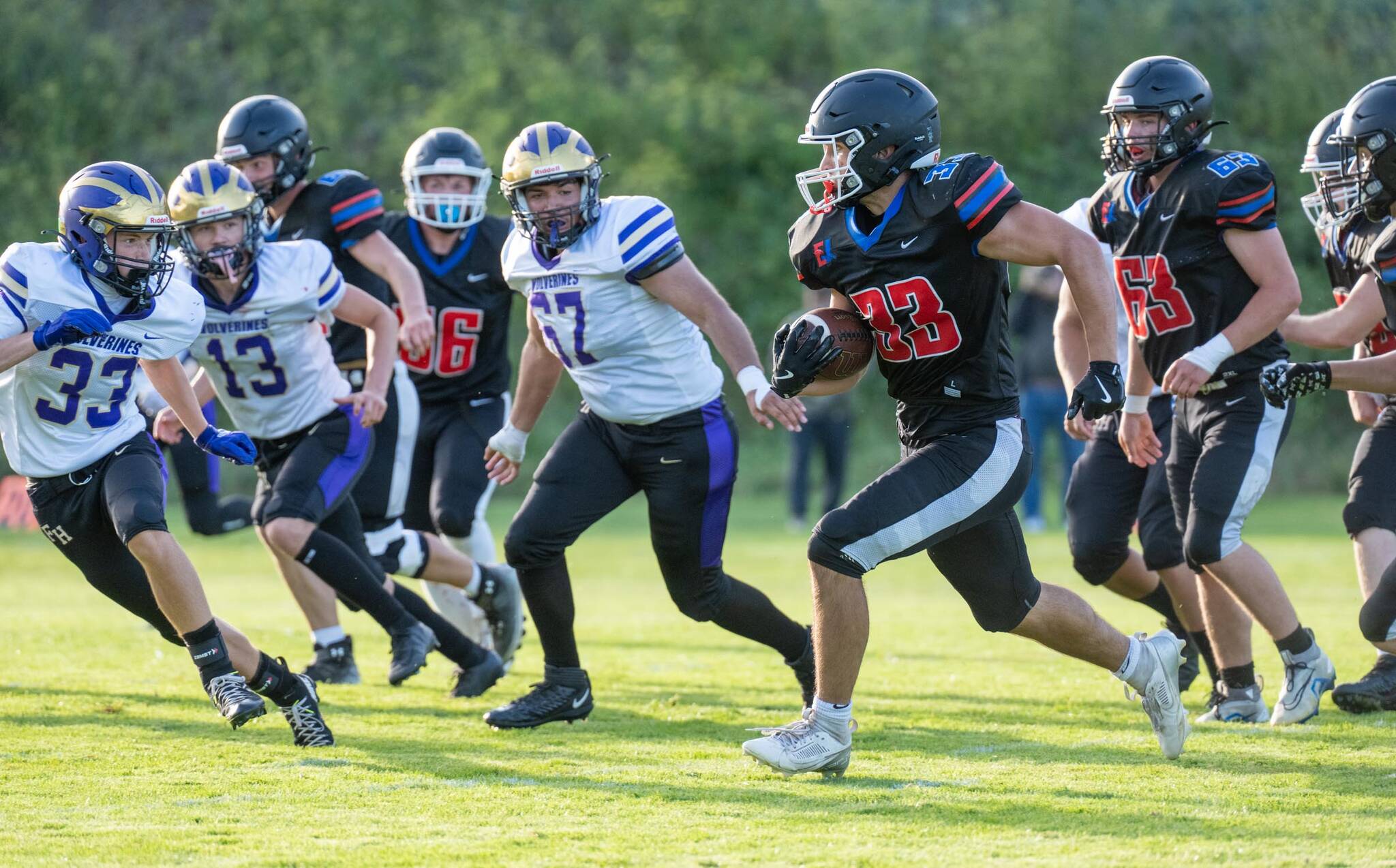 East Jeffersons Luke OHara runs a gauntlet of Friday Harbor defenders during a Friday night non-league game played against Friday Harbor in Port Townsends Memorial Field. East Jefferson won 14-13. (Steve Mullensky/for Peninsula Daily News)