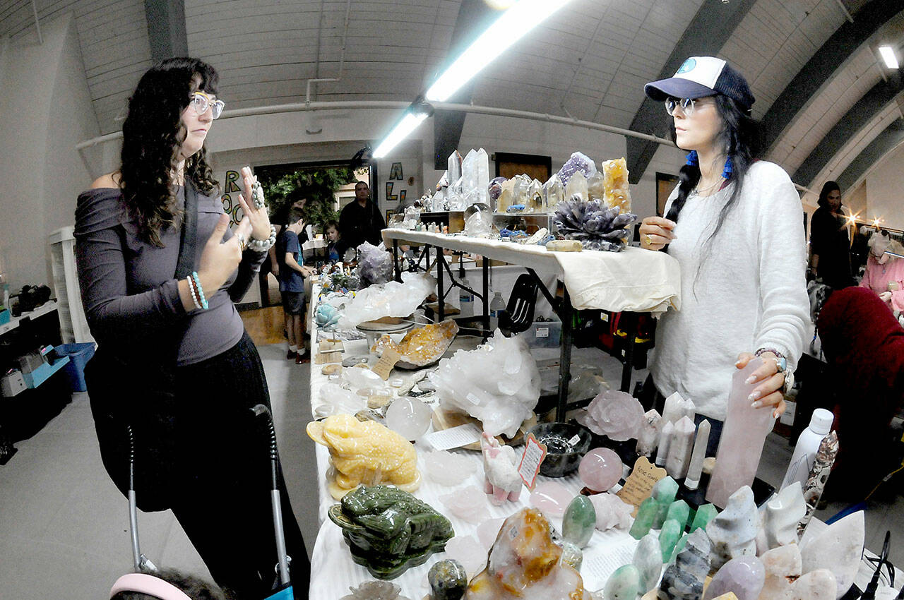 Julianna Milles of Sequim, left, and Tama Juarez of Seattle-based Inchel Crystals discuss jewelry at the 2025 Rock, Gem and Jewelry Show on Saturday at the Vern Burton Community Center in Port Angeles. The two-day event, hosted by the Clallam County Gem & Mineral Association, featured numerous vendors offering a selection of gems, rocks, fossils, crystals, beads and finished jewelry. (Keith Thorpe/Peninsula Daily News)