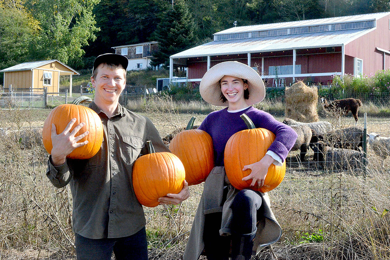 White Lotus Farm’s Niall Motson, left, with Jules Spruill-Smith of Space Twins Provisions. (Elijah Sussman/Peninsula Daily News)