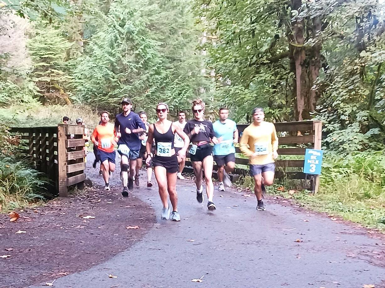 Runners begin heading up the hill between the starting line and the McFee Tunnell at the Spruce Railroad Trail run Saturday. (Pierre LaBossiere/Peninsula Daily News).