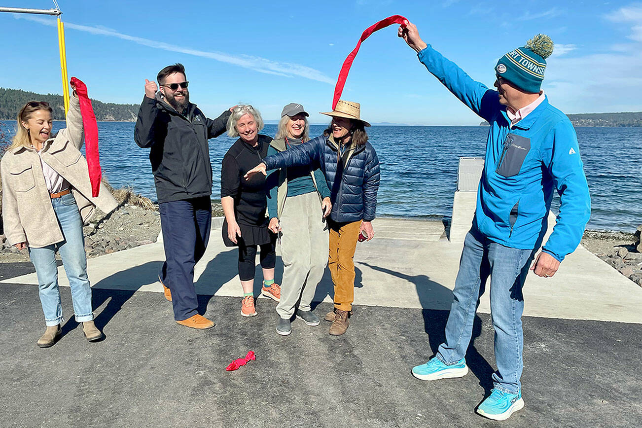 Port of Port Townsend project administrator Natalie Toews, left, Washington Recreation and Conservation Office Outdoor Grants Manager Brian Carpenter, Jefferson County Commissioner Heidi Eisenhour, Port of Port Townsend commissioners Carol Hasse and Pam Petranek and Port Executive Director Eron Berg cut the ribbon at the new Gardiner boat ramp and ADA-compliant boat launch on Discovery Bay. (Paula Hunt/Peninsula Daily News)