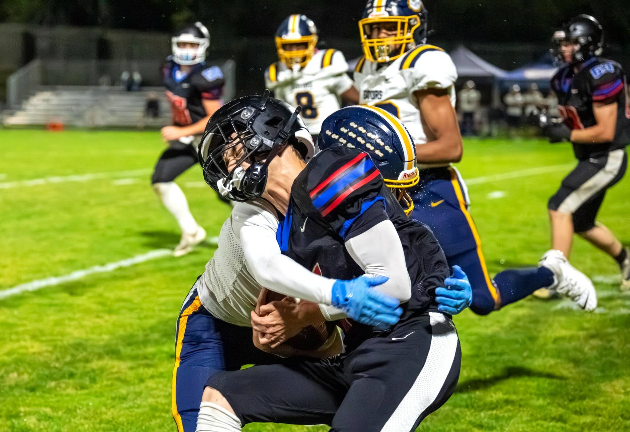 East Jefferson's Jackson Dupuy is tackled against Annie Wright last week. Dupuy gained 154 yards rushing Friday night against Bellevue Christian to help the Rivals beat the vikings 33-7. (Steve Mullensky/for Peninsula Daily News)