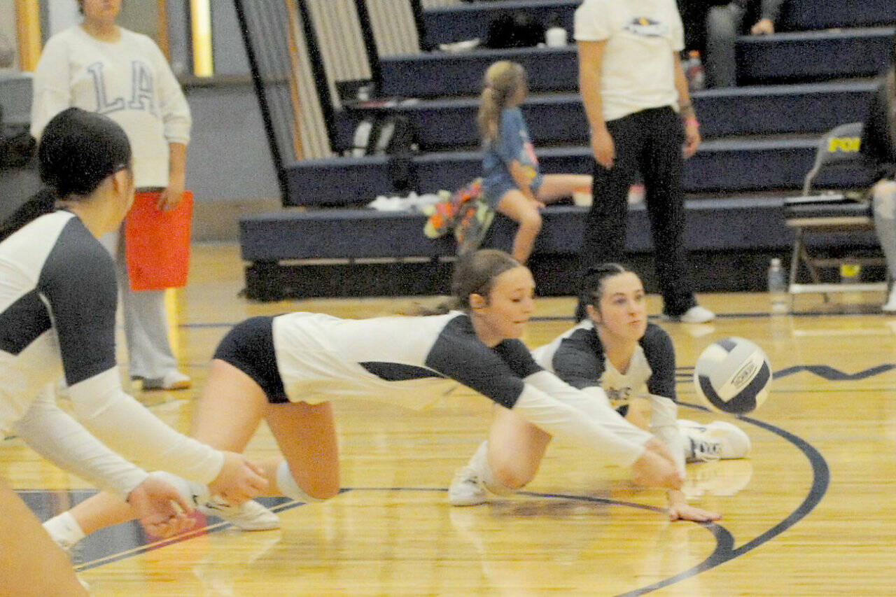 Forks Avery Dilley (center) and Chloe Gaydeski dig against Chief Leschi on Tuesday in Forks. The Spartans beat Chief Leschi 3-0. (Lonnie Archibald/for Peninsula Daily News)