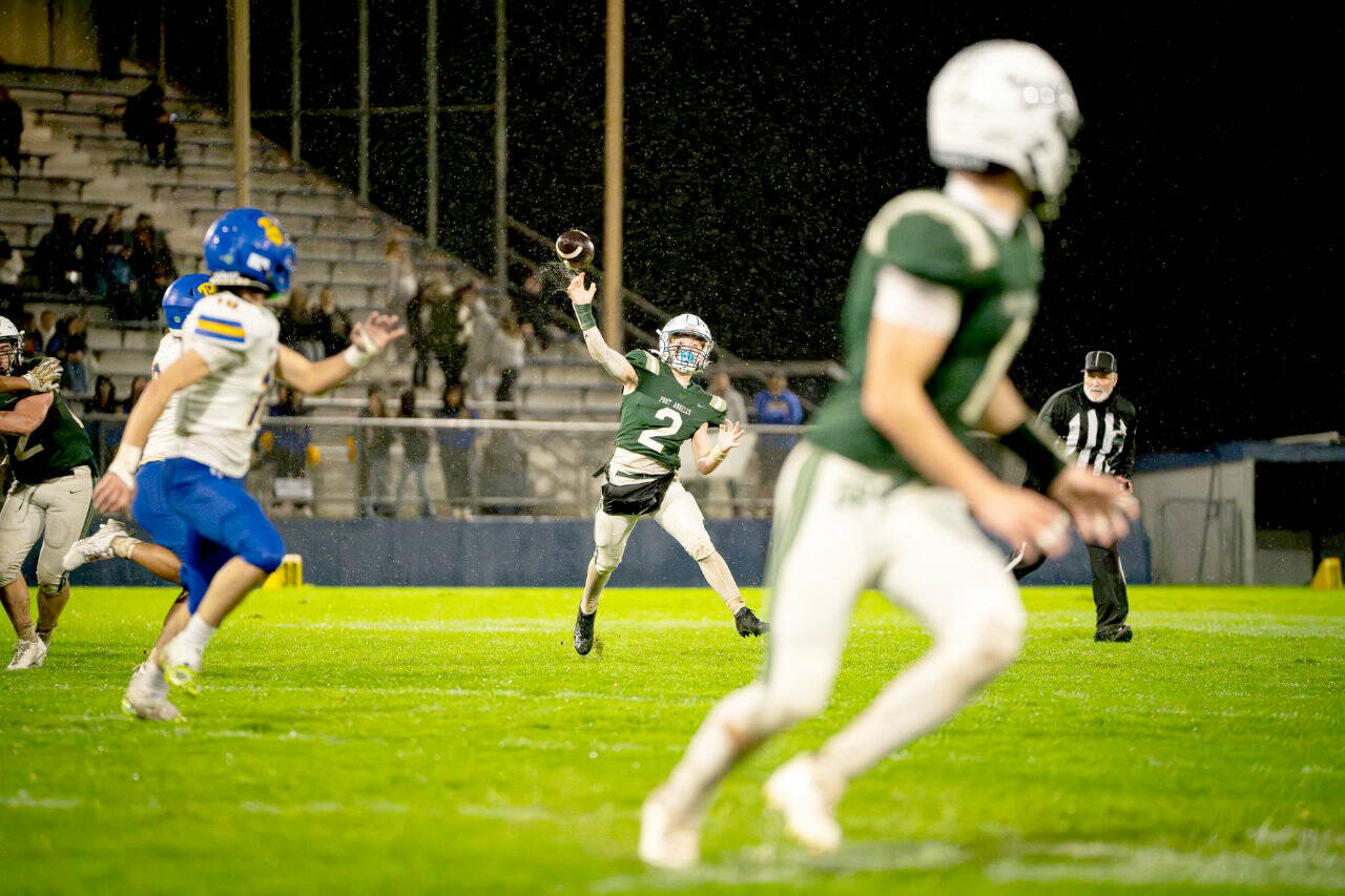 Port Angeles’ Carson Waddell (2) throws the ball against Bremerton on Friday night. Torrential rain at the beginning of the game affected play, especially in the first half. (Diamond Gentile/for Peninsula Daily News)