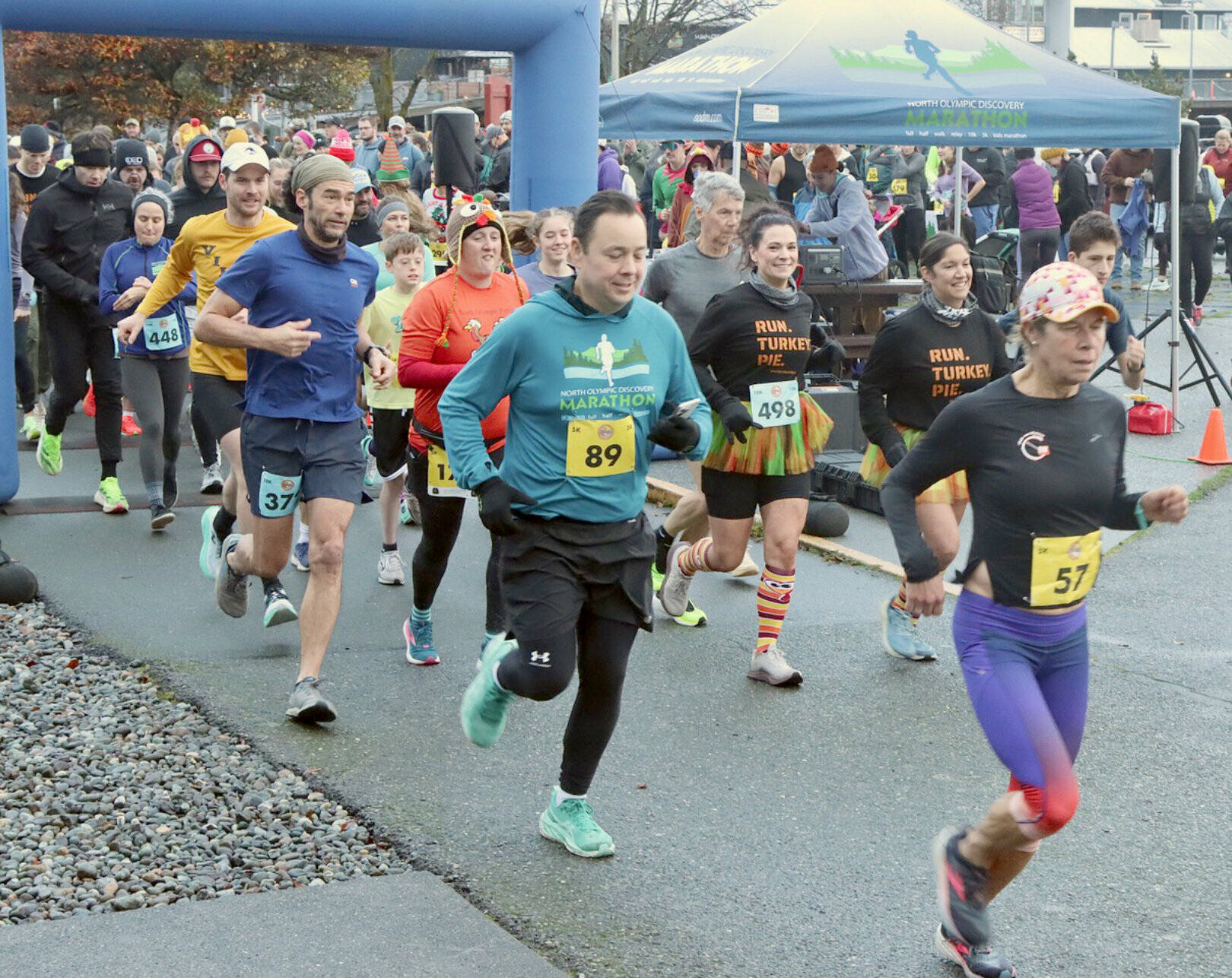 Runners take off at the Port Angeles waterfront in the annual Thanksgiving Day Turkey Trot. The men's 10K winner Michael Higuera (No. 372, in dark blue), is at the front of the pack. (Dave Logan/for Peninsula Daily News)