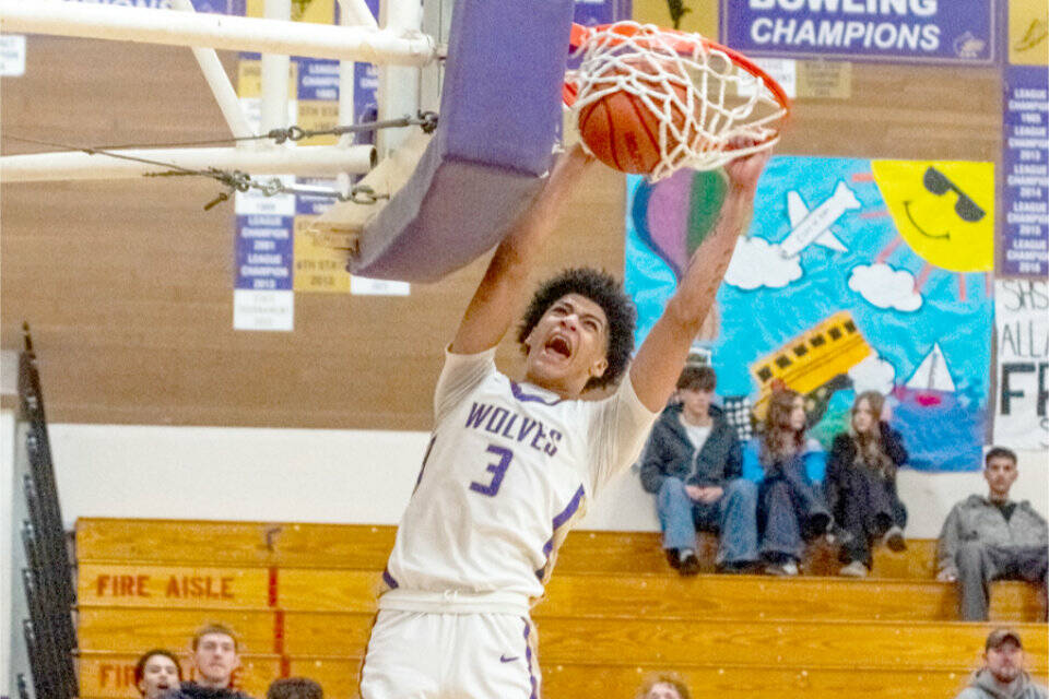 Sequim's Solomon Sheppard dunks late in the fourth quarter against Washington in the Wolves' 78-68 victory Saturday in Sequim. (Emily Matthiessen/for Peninsula Daily News)
