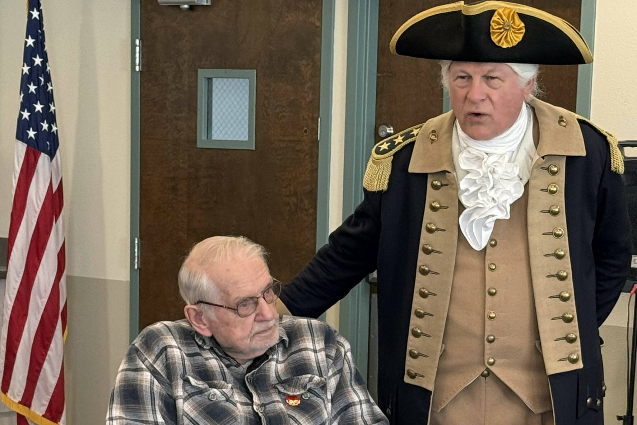 Vern Frykholm, who has made more than 500 appearances as George Washington since 2012, visits with Dave Spencer. Frykholm and 10 members of the New Dungeness Chapter, NSDAR, visited with about 30 veterans on Nov. 8, just ahead of Veterans Day. (New Dungeness Chapter DAR)