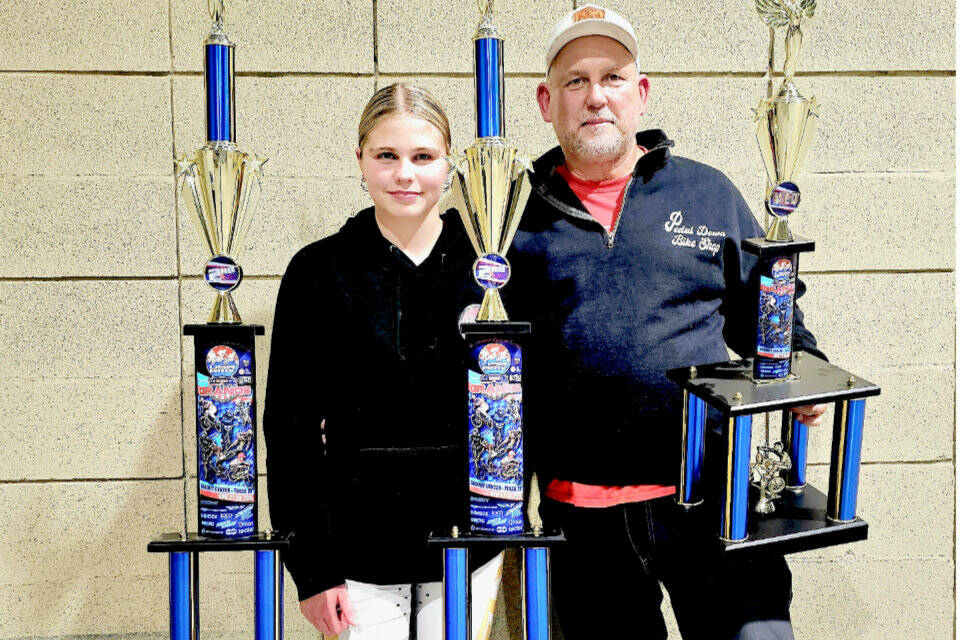 Kylin Weitz, 12, of Port Angeles, finished second in the 12 girls expert class and 12 girls cruiser class at the BMX USA Grant Nationals in Tulsa, Okla., last week, just seven weeks after fracturing her ankle at the world championships in Copenhagen. At right is Sean Coleman, Lincoln Park BMX operator, who finished seventh in the 51-55 novice class. (Britney Rowland)
