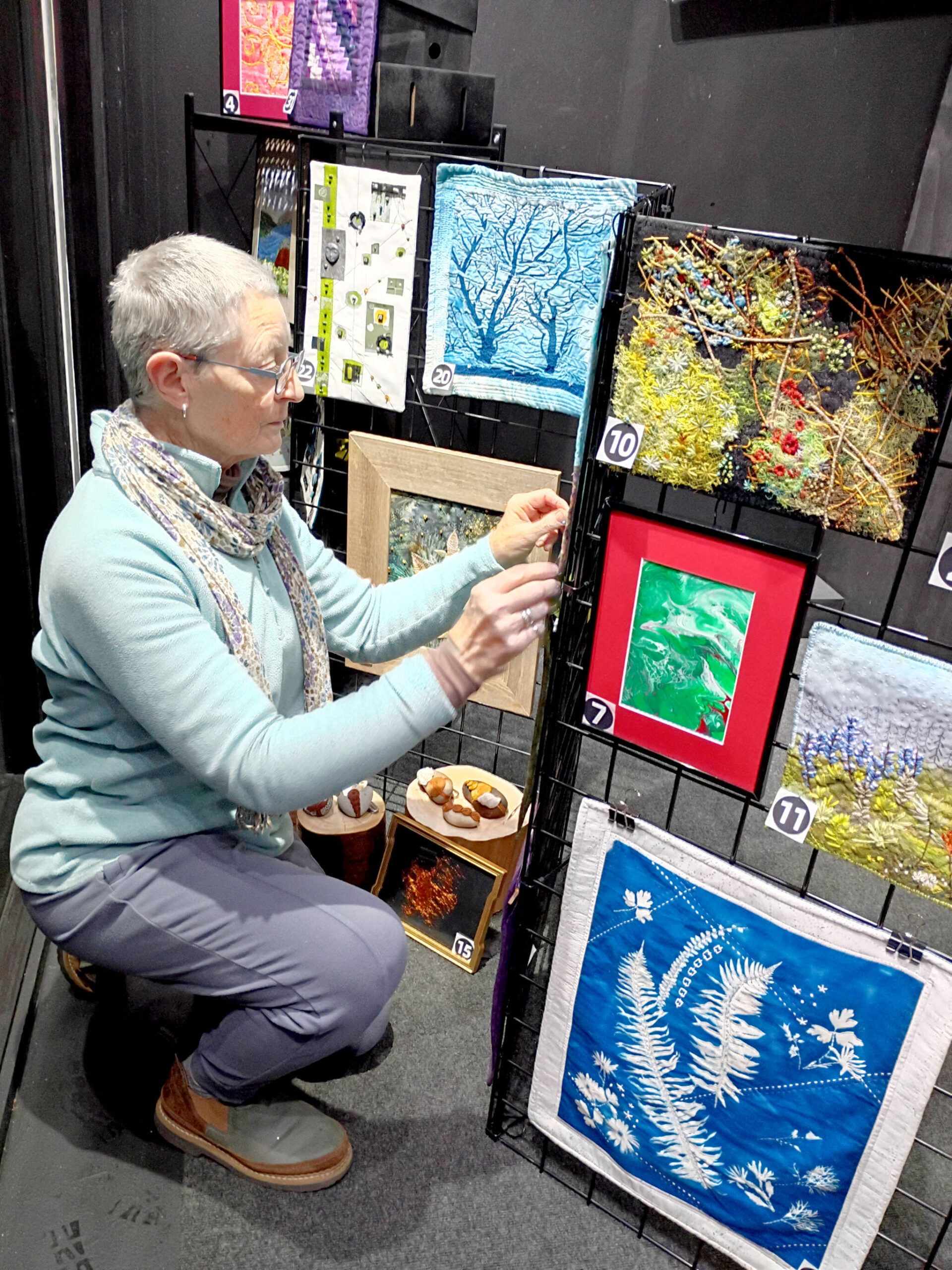 Debra E. Olson, a Port Townsend fiber artist, puts the finishing touches on the Small But Mighty exhibit at 675 Tyler St. in uptown Port Townsend.