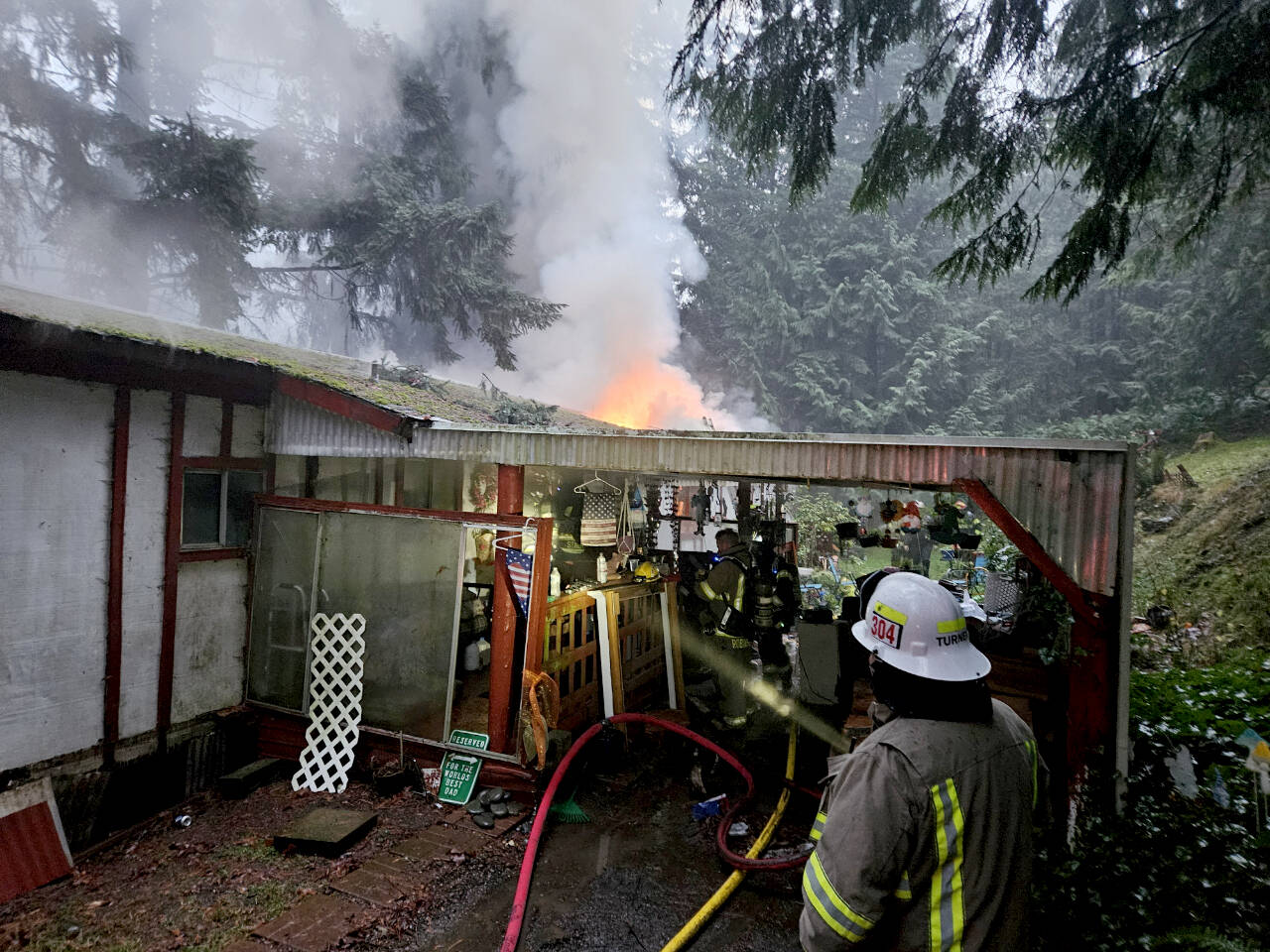 Clallam 2 Fire-Rescue personnel fight a residential structure fire in the 2000 Block of Dan Kelly Road on Wednesday. (Clallam 2 Fire Rescue)