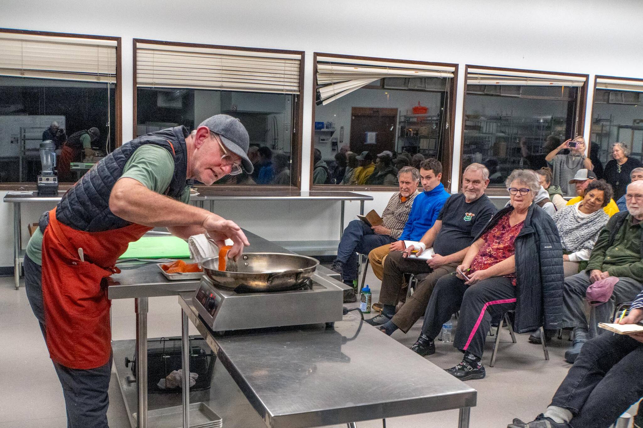 TSR 
Steve Mullensky/for Peninsula Daily News
Chef Arron Stark gently inserts a piece of king salmon into a hot saute pan so as not to cause a splatter of hot oil. Stark was presenting a cooking demonstration to 35 people on Wednesday December 10th at the Jefferson County Fairgrounds who paid $30.00 each for the privilege of learning from one of the best chefs in the county.