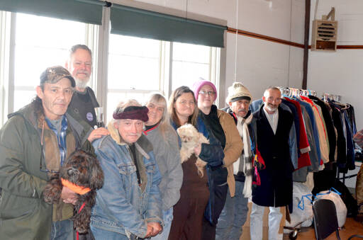 From left to right, Frank Hill, holding his dog Stoli, Joseph D. Jackson, Arnold Lee Warren, Executive Director Julia Cochrane, monitor Janet Dizick, holding dog Angel, Amanda Littlejohn, Fox and Scott Clark. (Elijah Sussman/Peninsula Daily News)