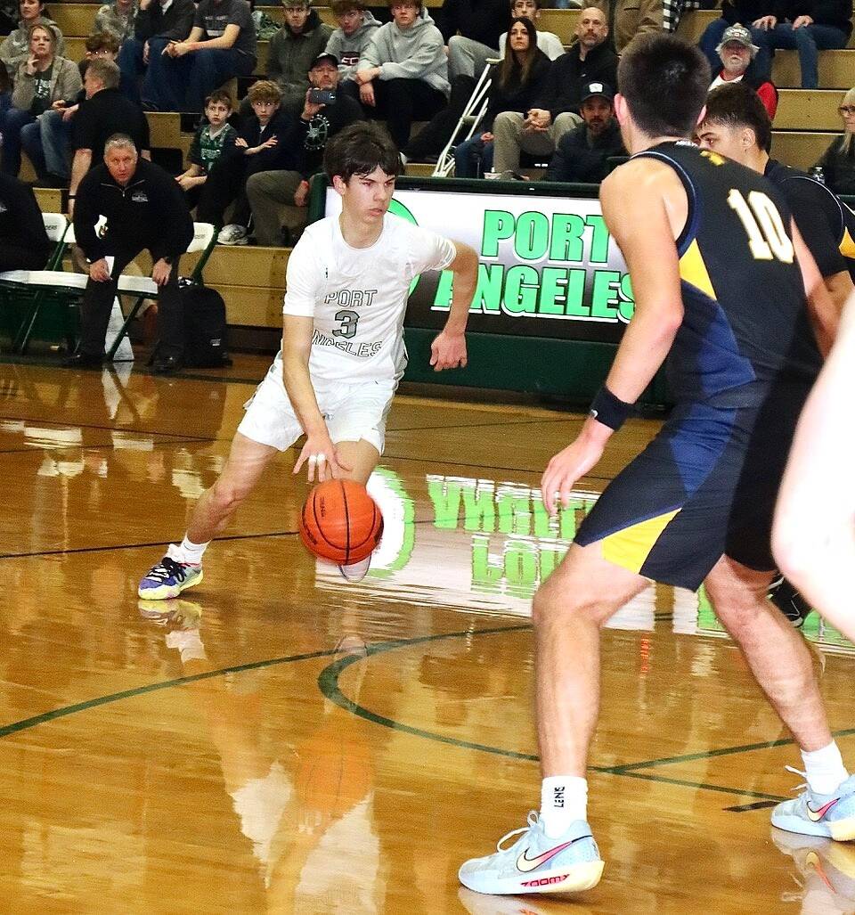 Port Angeles Brody Pierce drives the lane against Bainbridge on Friday in Port Angeles. The short-handed Roughriders kept pace with the Spartans until the final three minutes of the first half. (Dave Logan/for Peninsula Daily News)