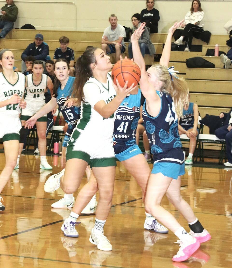 Port Angeles Sariah Doherty drives the lane against the Surfcoast Chargers, a team from Melbourne, Australia. (Dave Logan/for Peninsula Daily News)