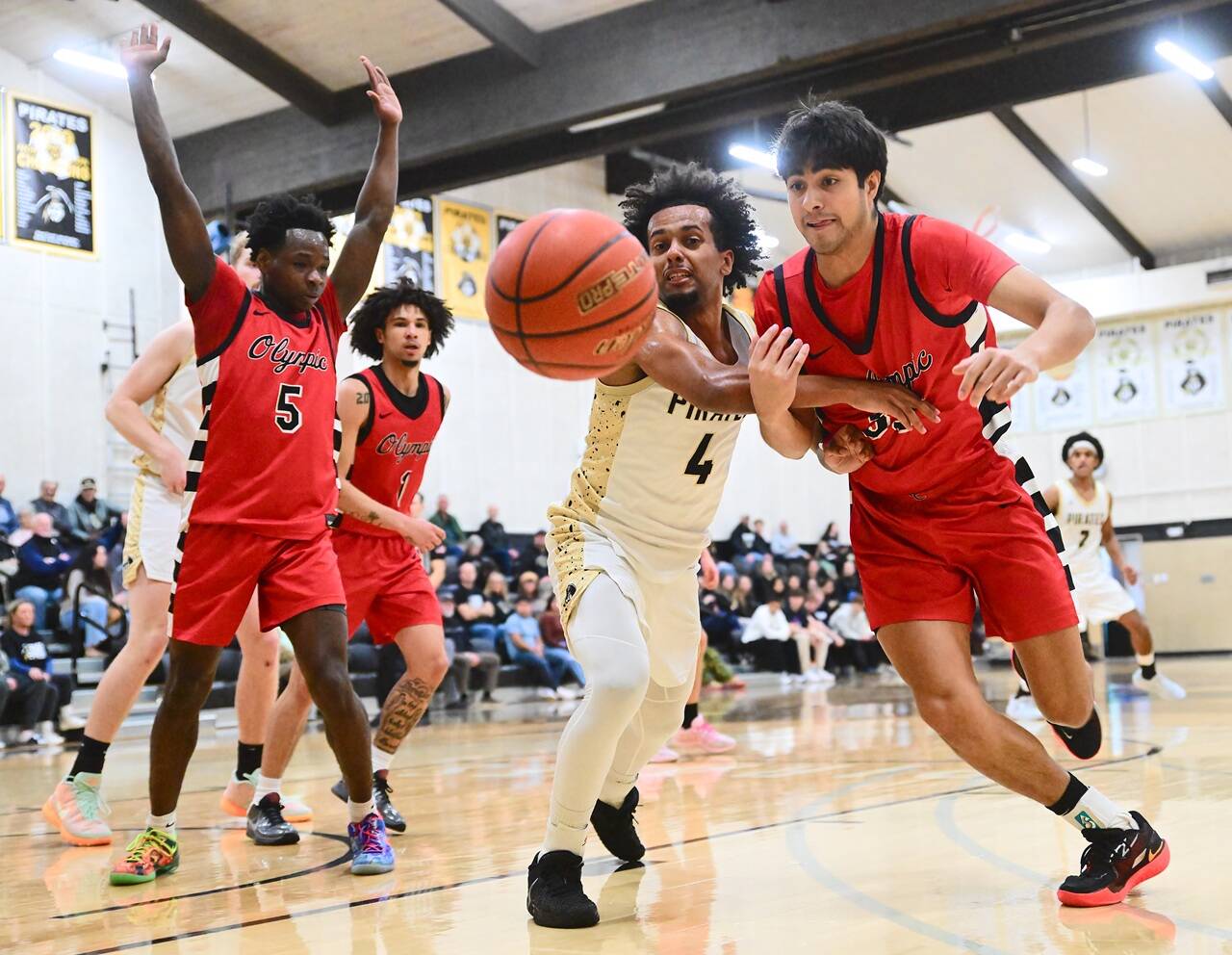 Peninsula Colleges Patrick Odingo (4) battles Olympic for a loose ball Saturday in Port Angeles. The Peninsula men beat Olympic 102-66. (Jay Cline/Peninsula College)