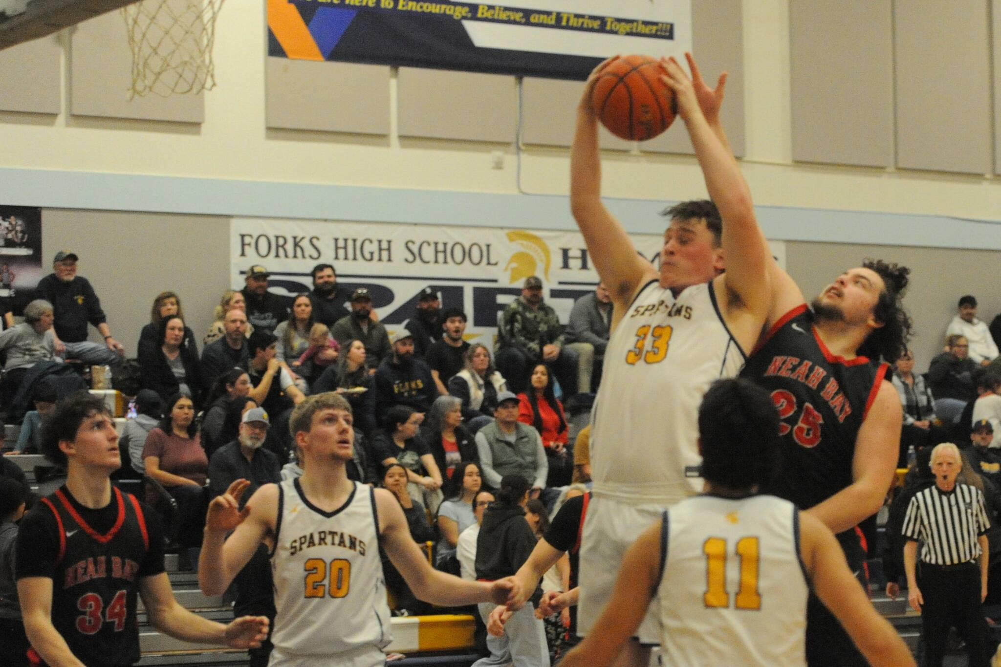 Forks Radly Benett, left, rebounds in front of Neah Bays Daniel Cumming on Thursday night in Forks.