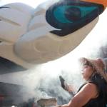 Linda Soriano of the Lummi Nation performs a smudge ceremony at Saint Mark&rsquo;s Episcopal Cathedral in Seattle last Thursday, fanning smoke from burning sage with eagle feathers onto a totem pole. The 22-foot-tall Lummi Nation totem pole is traveling nearly 5,000 miles across the U.S. and Canada to galvanize opposition to the development of fossil fuel infrastructure, particularly around sea ports in Oregon and Washington. (Manuel Valdes/The Associated Press)