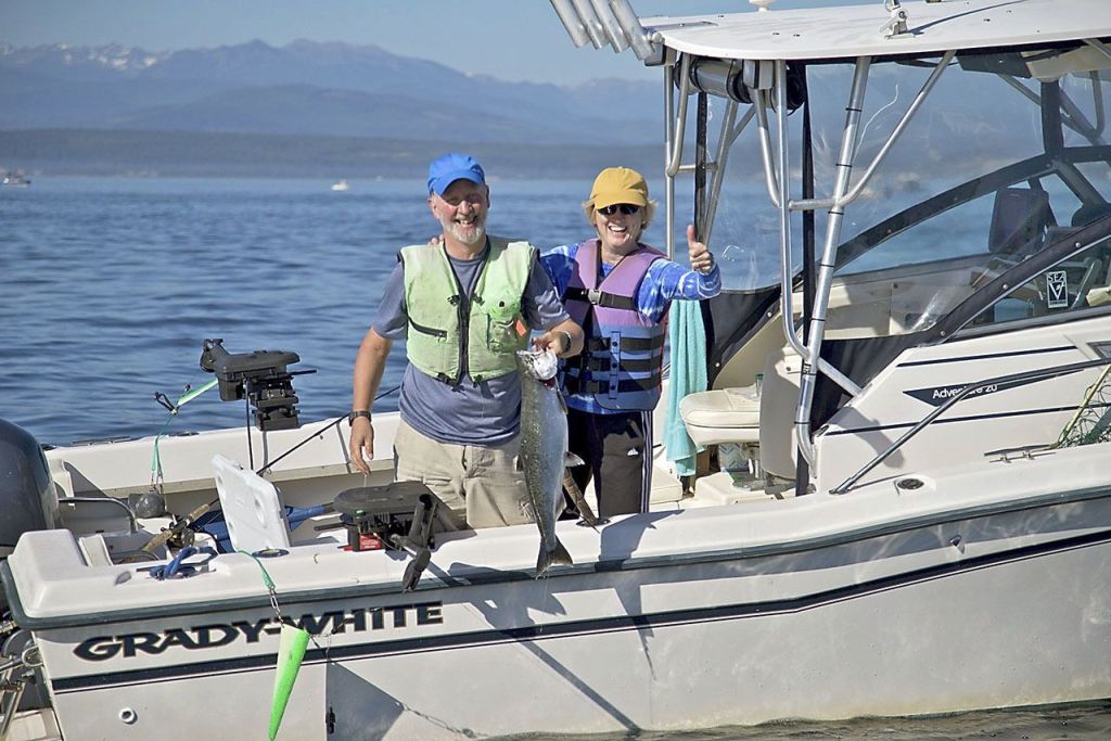 Steve Mullensky/for Peninsula Daily News                                John Reed and Karen Overstreet, both fof Seattle, show off a chinook caught while fishing at Midchannel Bank off Port Townsend.