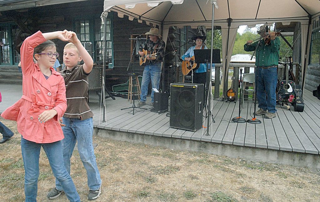 Siblings Adam Chloe Corey and Adam Corey, both 11 of Port Angeles, dance to the music of Wanda Bumbarner & Friends on the lawn of the Joyce Museum on Saturday. (Keith Thorpe/Peninsula Daily News)