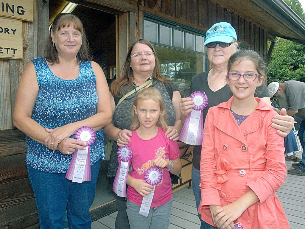 The winners of the Joyce Daze Wild Blackberry Festival pie contest were, front row from left, Lily Robertson, 8, and Chloe Corey, 11 in the youth category, and backrow from left, Katy Thompson of Port Angeles, Linda Dechant of Joyce and Jo Roger of Joyce. Not pictured was Lauren Stephens, 10, in the youth category. (Keith Thorpe/Peninsula Daily News)