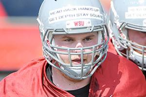 After testicular cancer diagnosis and losing both parents, Washington State lineman Riley Sorenson is seeing his way through