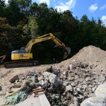 A backhoe works at regrading the soil and rocks as part of a shoreline restoration project at Fort Townsend State Park. (Jesse Major/Peninsula Daily News)
