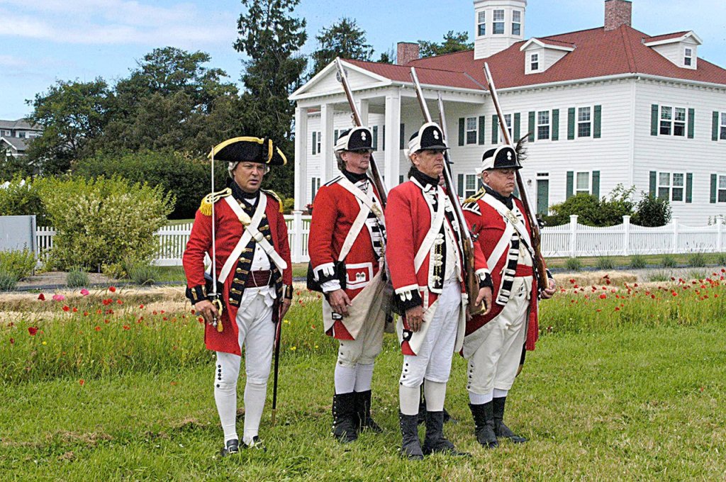 Jack Paul, left, portraying Major Redmayne, leads enlisted men with the 7th Company, Brigade of Guards &mdash; a re-created unit of the British army in the American colonies during the fighting from 1775 to 1783 &mdash; during the first day of the inaugural colonial festival last year at George Washington Inn. (Chris McDaniel/Peninsula Daily News)