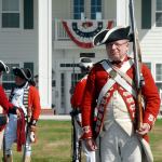 British redcoat reenactor John Hess of Fairplay, Calif., stands guard at the gate to the George Washington Inn, the site of the Northwest Colonial Festival. (Keith Thorpe/Peninsula Daily News)