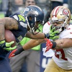 The Associated Press Seattle running back Thomas Rawls, left, pushes off San Francisco 49ers inside linebacker Michael Wilhoite, right, as he runs for a touchdown during the second half of an NFL football game, Sunday, Nov. 22, 2015, in Seattle.