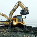 Heavy lifting took place on the Elwha nearshore as backhoes removed rock armoring from the river&rsquo;s mouth. (Anne Shaffer)