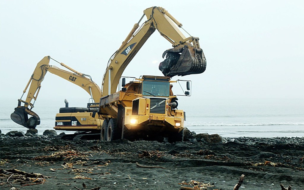 Heavy lifting took place on the Elwha nearshore as backhoes removed rock armoring from the river&rsquo;s mouth. (Anne Shaffer)