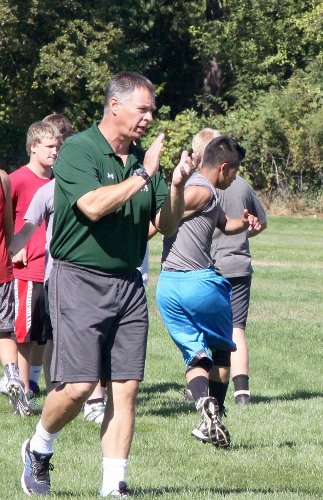 Dave Logan/for Peninsula Daily News Port Angeles head coach Bret Curtis applauds his players&rsquo; effort at an early-season practice.