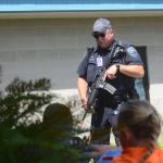 Randy Kellas of the Sequim Police Department talks to children during a school shooting drill at Greywolf Elementary School in Carlsborg on Friday. (Jesse Major/Peninsula Daily News)