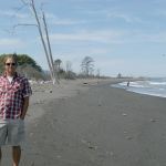 Jamie Michel, nearshore biologist with the Coastal Watershed Institute, stands on a newly formed beach east of the Elwha River Mouth on Friday. (Rob Ollikainen/Peninsula Daily News)