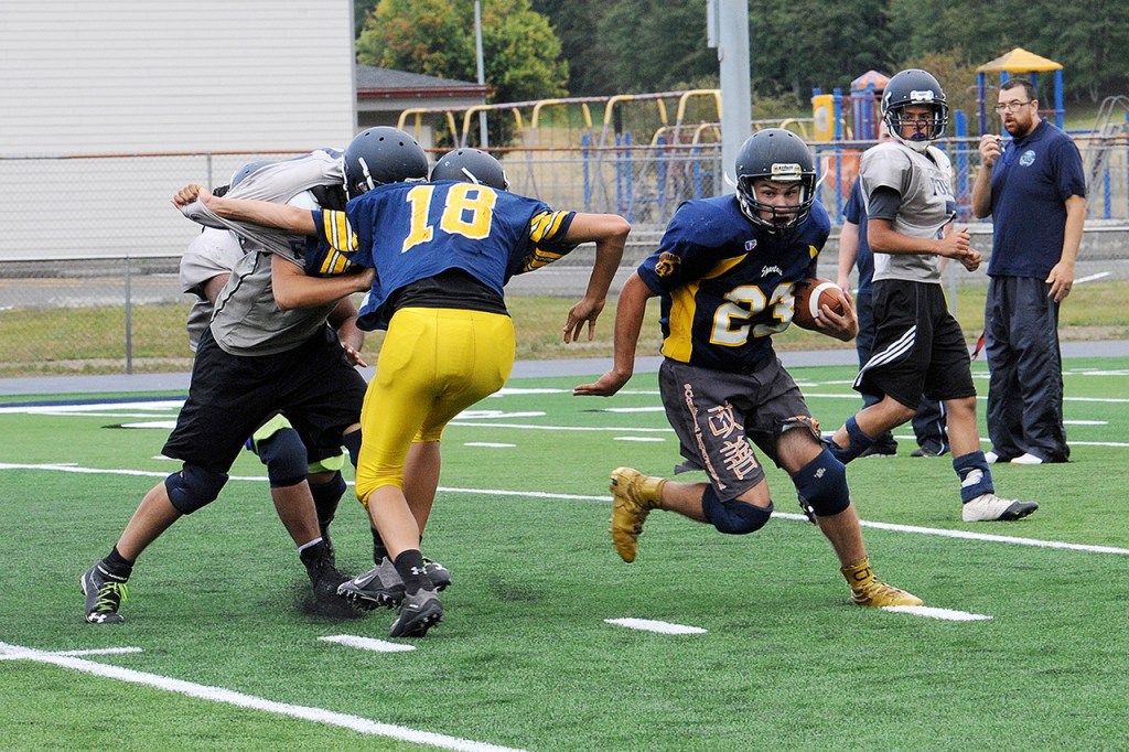 Lonnie Archibald/For Peninsula Daily News Forks running back Kenny Gale looks for running room during practice Tuesday on the new Spartan Stadium FieldTurf playing surface.