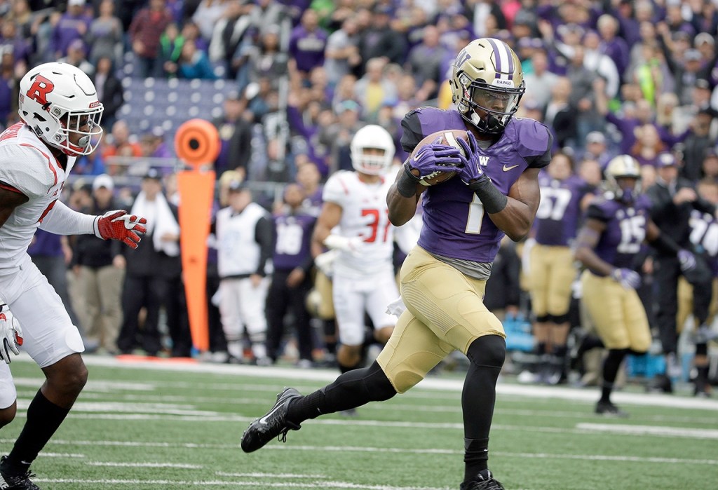 The Associated Press Washington&rsquo;s John Ross scores on a 50-yard pass against Rutgers in the first half of the Huskies 48-13 blowout victory.