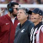 Washington State head coach Mike Leach, center, watches a replay during the first half of an NCAA college football game against the Eastern Washington in Pullman, Wash., Saturday, Sept. 3, 2016. (AP Photo/Young Kwak)