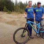 Jason Queen and Lily Hickenbottom stand in front of the bike track at H.J. Carroll Park in Chimacum. The two, along with Doug Ross and support from Jefferson County Parks and Recreation, hope to update the track to make it more usable for local riders. (Cydney McFarland/Peninsula Daily News)