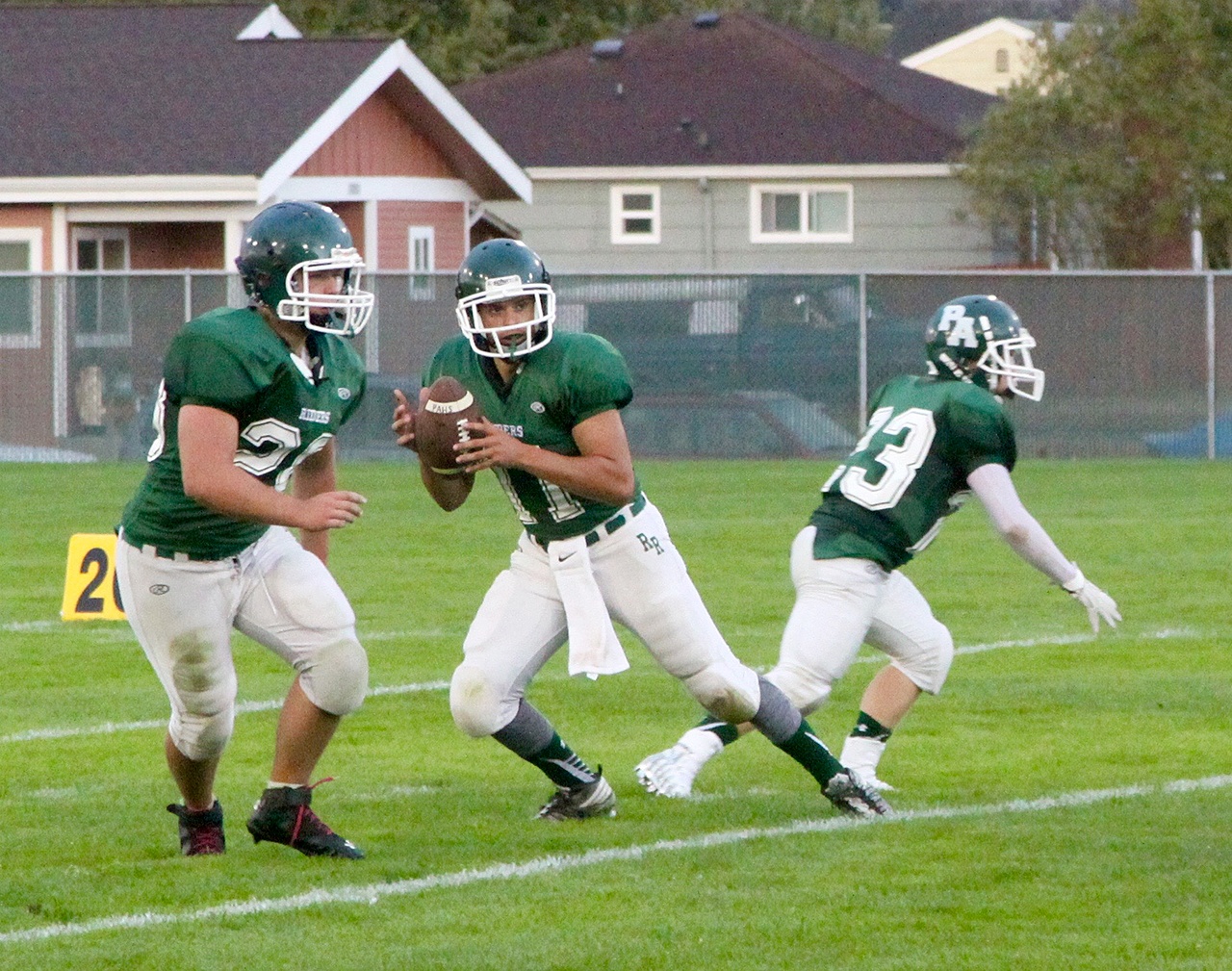 Dave Logan/For Peninsula Daily News Port Angeles quarterback Matthew Warner, center, goes back for a pass as he is defended by Jace Lausche, left, and Trevor Shumway.