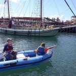 Marina crews at Port Townsend&rsquo;s Point Hudson Marina help guide a sail boat to the docks which will be filled with boat for this weekend&rsquo;s Wooden Boat Festival. (Cydney McFarland/Peninsula Daily News)