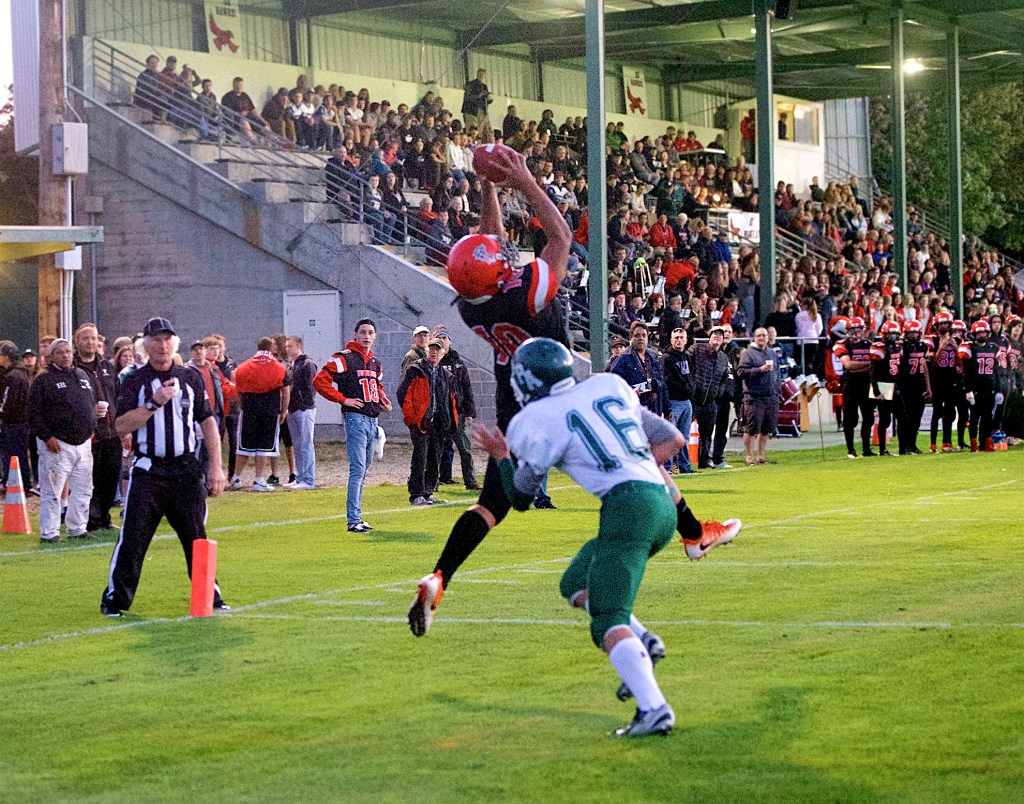 Steve Mullensky/for Peninsula Daily News Redhawk Detrius Kelsall, 10, beats out Roughrider Easton Joslin and makes the catch in the end zone for a touchdown during a non-league game in Memorial Field in Port Townsend on Thursday.
