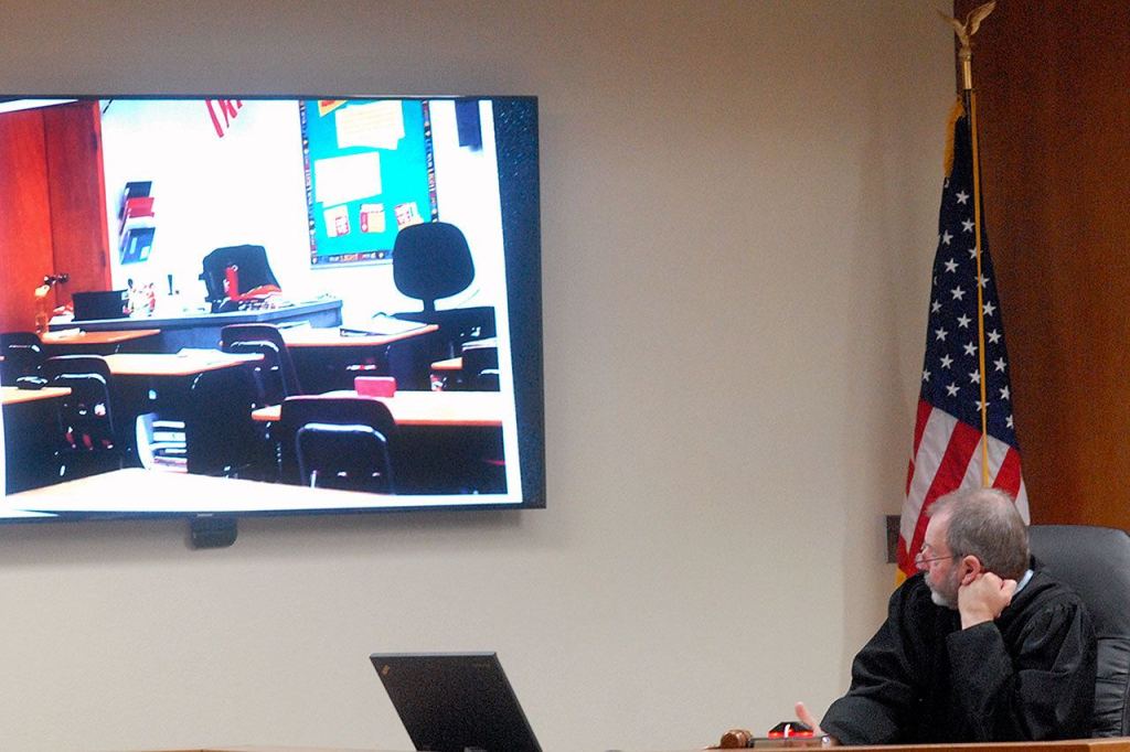 Clallam County Superior Court Judge Christopher Melly looks at a projected image of the Mountain View Christian School classroom where Douglas Allison molested and raped two of his students. (Keith Thorpe/Peninsula Daily News)