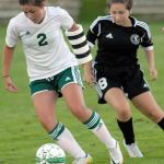 Keith Thorpe/Peninsula Daily News                                Nicole Heaton of Port Angeles, left, dribbles past Port Townsend&rsquo;s Samantha Heron in first-half action on Tuesday at Port Angeles Civic Field.