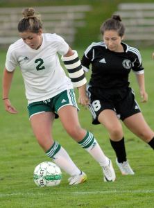 Keith Thorpe/Peninsula Daily News                                Nicole Heaton of Port Angeles, left, dribbles past Port Townsend&rsquo;s Samantha Heron in first-half action on Tuesday at Port Angeles Civic Field.
