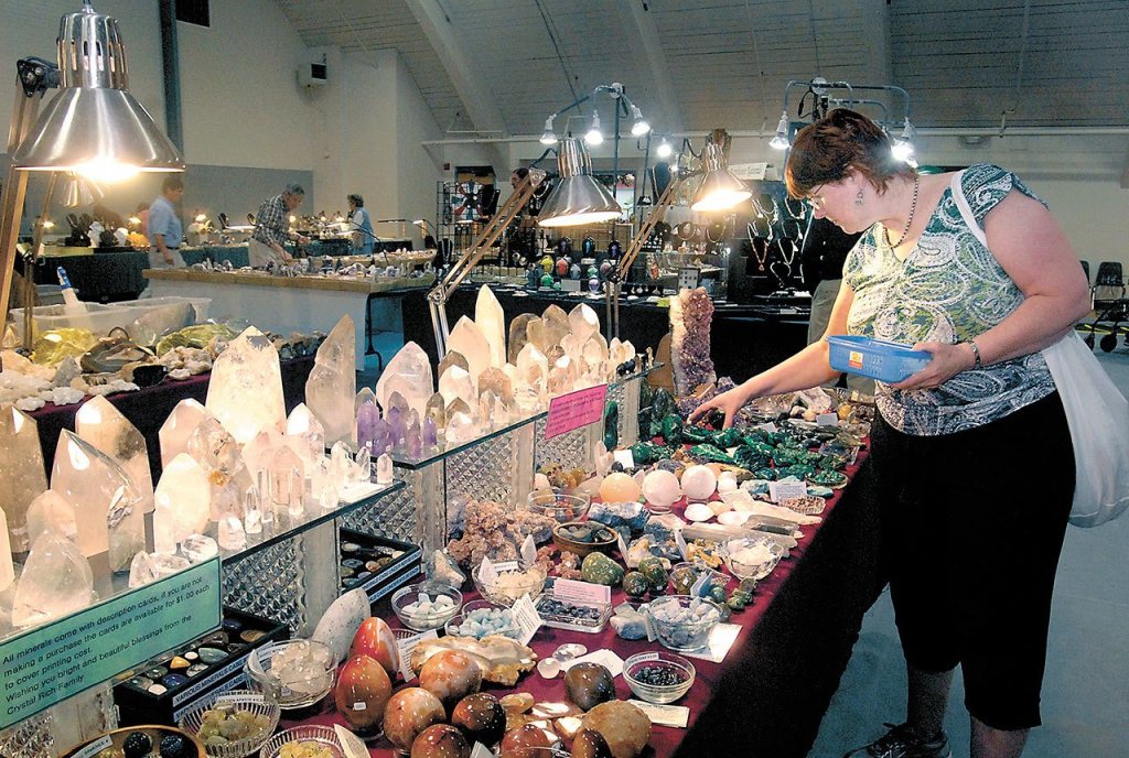 Barbara Deese of Port Angeles looks over a table filled with crystals and minerals during last year&rsquo;s Rock and Gem Show at Vern Burton Community Center in Port Angeles. (Keith Thorpe/Peninsula Daily News)