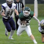 Keith Thorpe/Peninsula Daily News Port Angeles&rsquo; Trevor Shumway tries to evade the North Kitsap defense, including Oliver Chapmen, left, during the first quarter of Friday night&rsquo;s game at Port Angeles Civic Field.