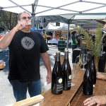 Shelly and John Barone of Port Angeles drink samples of beer served by Piper Corbett of the Port Townsend-based Propolis Brewing during the Arts & Draughts festival of beer, wine, cider, arts and music in downtown Port Angeles last year. (Keith Thorpe/Peninsula Daily News)
